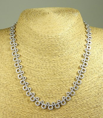 Lot 58 - An 18 carat white gold and diamond set...