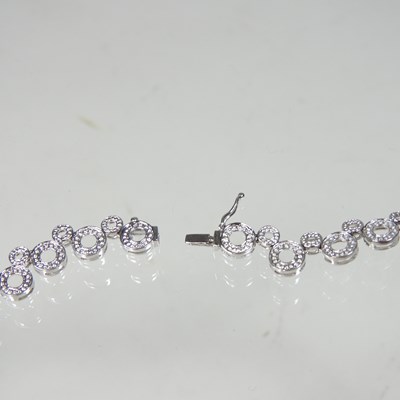 Lot 58 - An 18 carat white gold and diamond set...