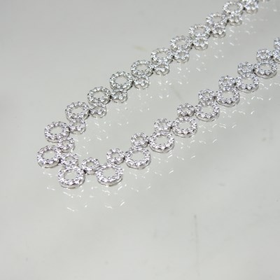 Lot 58 - An 18 carat white gold and diamond set...