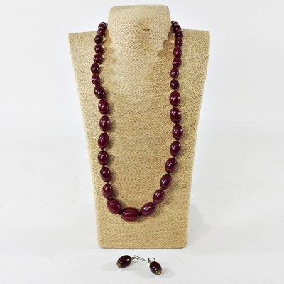 Lot 21 - A modern cherry bakelite coloured graduated...