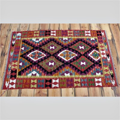 Lot 270 - An Afghan kilim rug, decorated with diamonds,...