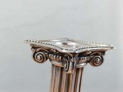 Lot 131 - A pair of George III silver candlesticks, each...