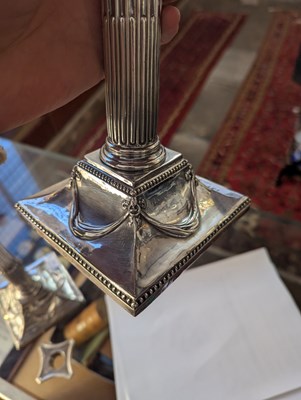 Lot 131 - A pair of George III silver candlesticks, each...