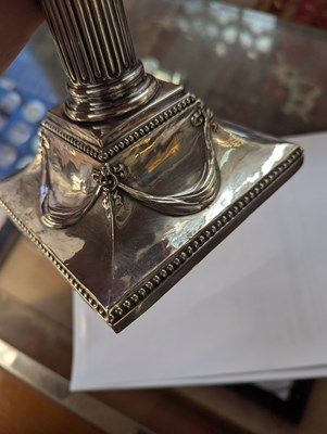Lot 131 - A pair of George III silver candlesticks, each...