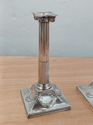 Lot 131 - A pair of George III silver candlesticks, each...