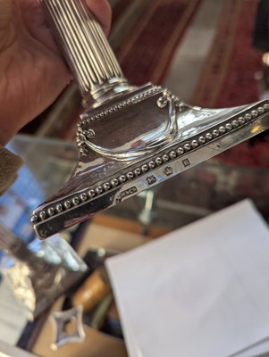 Lot 131 - A pair of George III silver candlesticks, each...