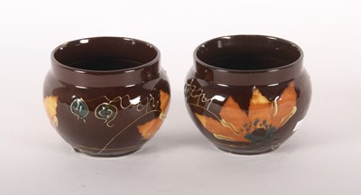Lot 111 - A pair of brown glazed floral decorated...