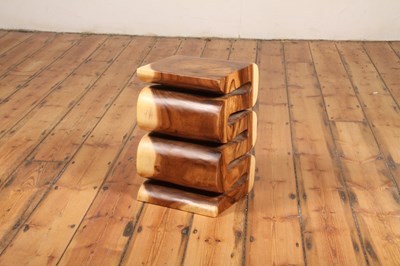 Lot 70 - An Indonesian carved teak stool, of a flowing,...