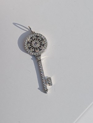 Lot 119 - An 18ct white gold Tiffany diamond key pendant,...