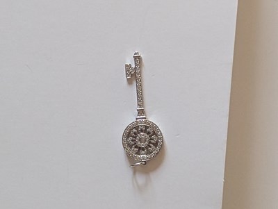 Lot 119 - An 18ct white gold Tiffany diamond key pendant,...