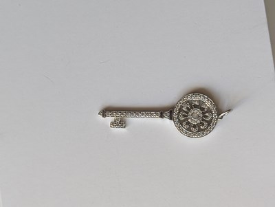 Lot 119 - An 18ct white gold Tiffany diamond key pendant,...