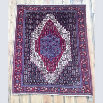 Lot 601 - A Persian Senneh rug, having a large ivory...
