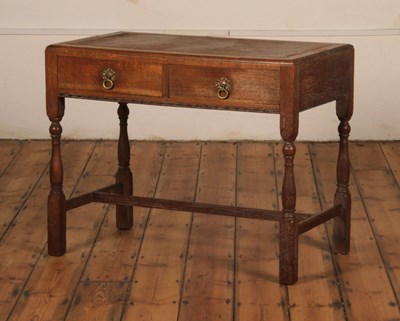 Lot 70 - A limed oak writing table, early 20th century,...