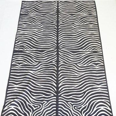Lot 647 - A large black and white faux zebra skin rug,...