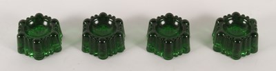 Lot 291 - A set of four early 20th century green glass...
