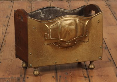 Lot 63 - An Art Nouveau brass-sided log box, the brass...
