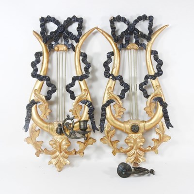 Lot 671 - A pair of gilt wall sconces, each in the form...