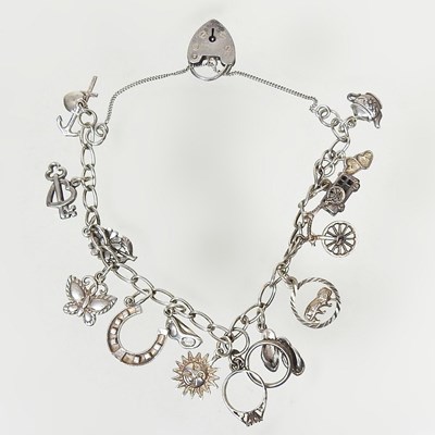 Lot 51 - A silver charm bracelet, suspended with a...