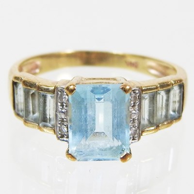 Lot 69 - A 9 carat gold, topaz and diamond dress ring,...