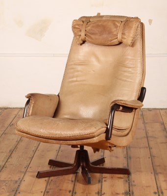 Lot 48 - A Danish tan leather upholstered armchair, on...