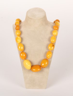 Lot 212 - A butterscotch amber barrel bead necklace, on...