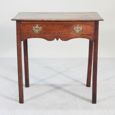 Lot 472 - An 18th century oak side table, with a shaped...