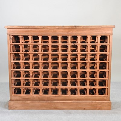 Lot 59 - A large handmade pine wine rack, on a plinth base