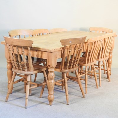 Lot 372 - A pine dining table, on turned legs, together...