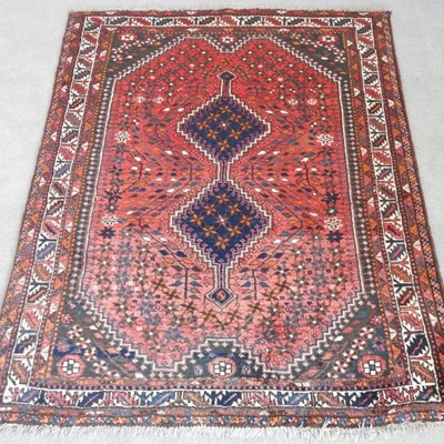 Lot 138 - An Afghan rug, with two central diamonds, on a...