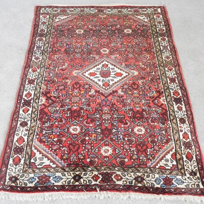 Lot 183 - A Persian woollen rug, with foliate designs,...