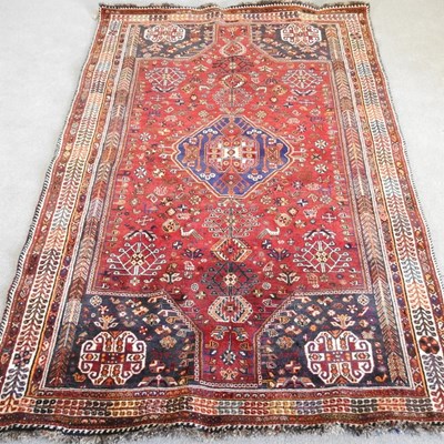 Lot 305 - A Persian rug, on red ground, 278 x 173cm,...