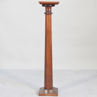 Lot 134 - A walnut jardiniere stand, in the form of a...