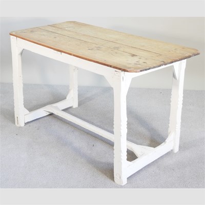 Lot 314 - A rustic painted pine dining table, with a...