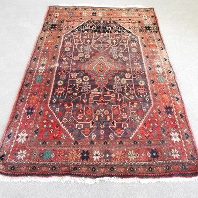 Lot 268 - A Persian carpet, with foliate motifs, on a...