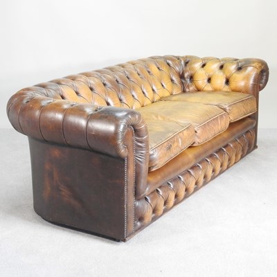 Lot 76 - A brown upholstered button back chesterfield sofa