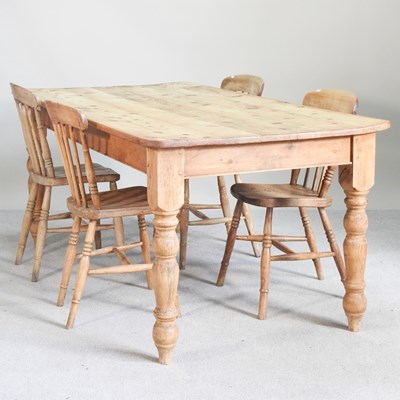 Lot 105 - A pine dining table, on turned legs, together...