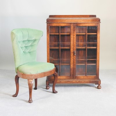 Lot 335 - A 1920s oak glazed bookcase, 84cm wide,...