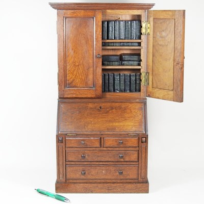 Lot 67 - An antique oak apprentice bureau bookcase,...