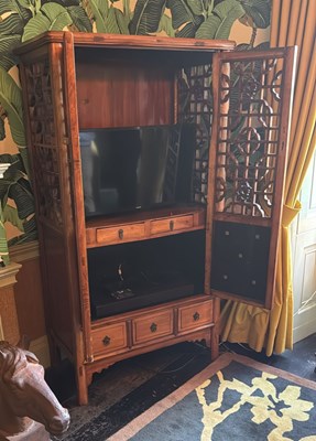 Lot 21 - A Chinese cabinet, the pierced doors opening...