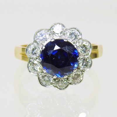 Lot 34 - An 18 carat gold sapphire and diamond cluster...