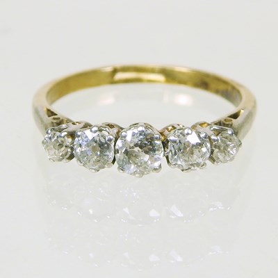 Lot 86 - An 18 carat gold and platinum set five stone...