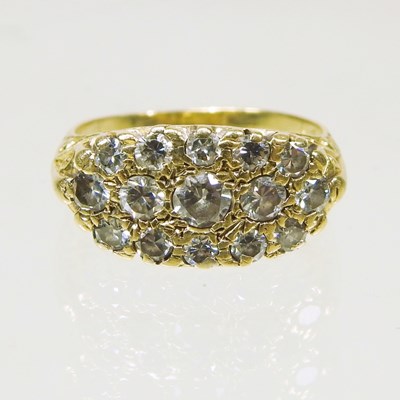 Lot 56 - An 18 carat gold and diamond dress ring, of...