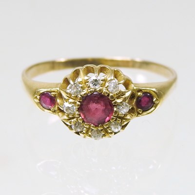 Lot 169 - An 18 carat gold ruby and diamond cluster ring,...