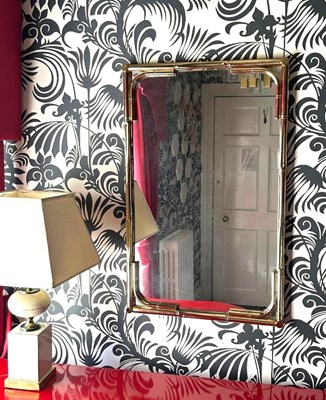 Lot 133 - A 1980s brass faux bamboo wall mirror, 88 x 57cm