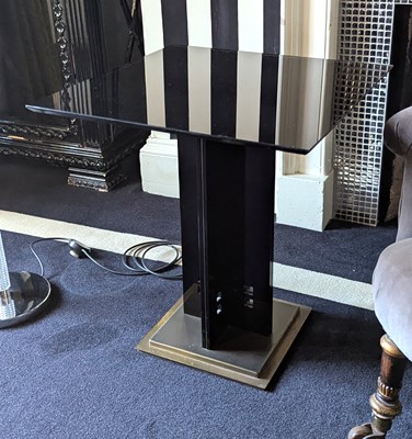 Lot 155 - A 1980's black glass and brass occasional...