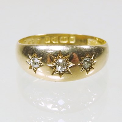 Lot 182 - An 18 carat gold three stone diamond gypsy...