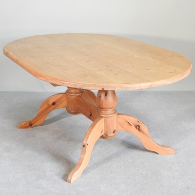 Lot 309 - A modern pine twin pillar dining table, on...