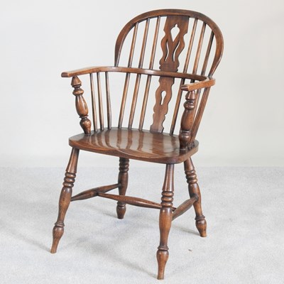 Lot 113 - A 19th century elm seated windsor armchair, on...