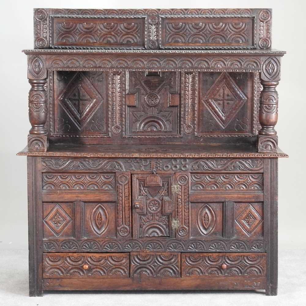 Lot 56 - A 17th century style heavily carved oak court...
