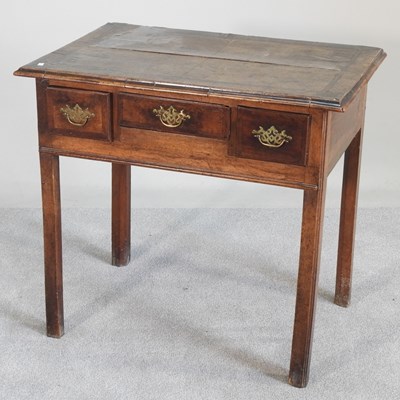 Lot 552 - An 18th century oak lowboy, on square legs